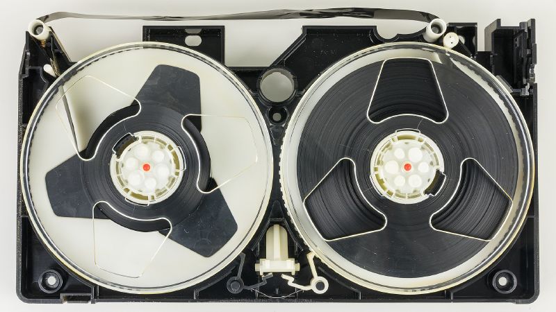 An opened VHS cassette showing the two tape reels inside.