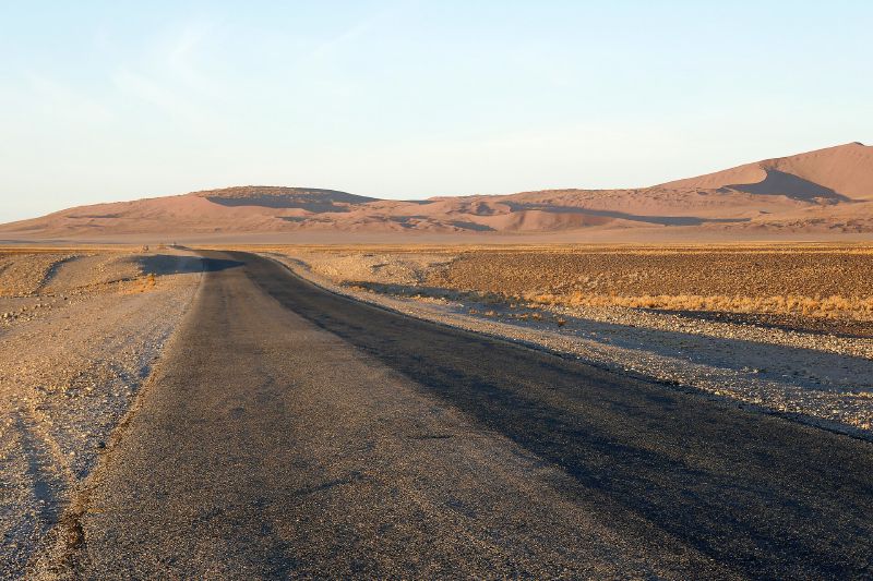 A straight road across the Namib desert in Namibia, the kind of landscape used for Mad Max: Fury Road.