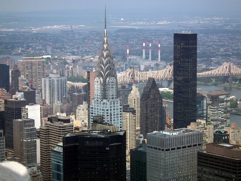 The Chrysler Building's spire among Midtown towers, with the Queensboro Bridge and the East River behind, seen from the Empire State Building