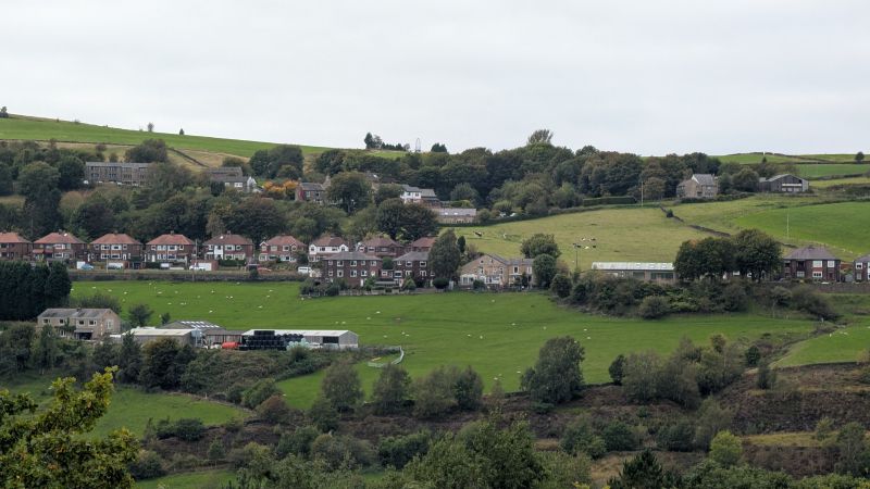 Green Pennine hills rise above the valley between Saddleworth and Mossley.